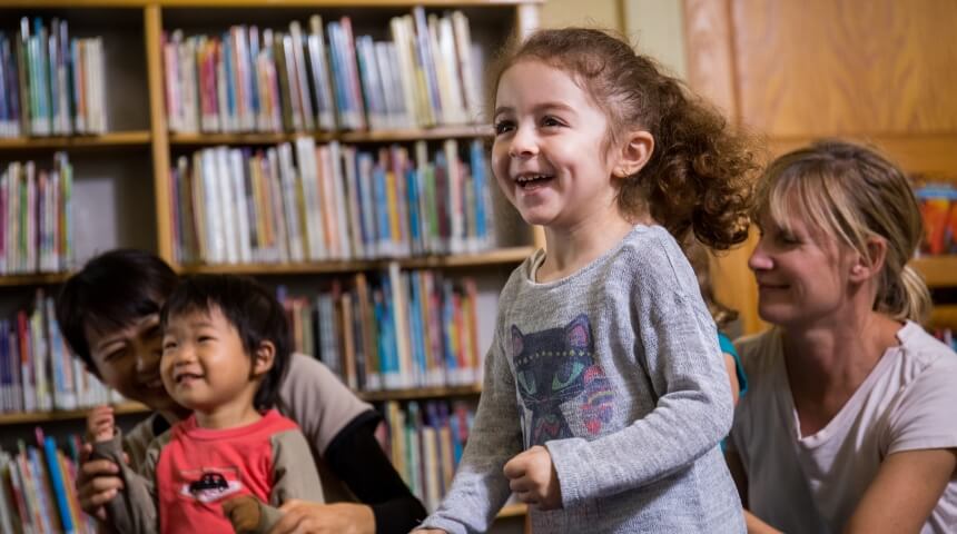 Two children and two adults participate in storytime