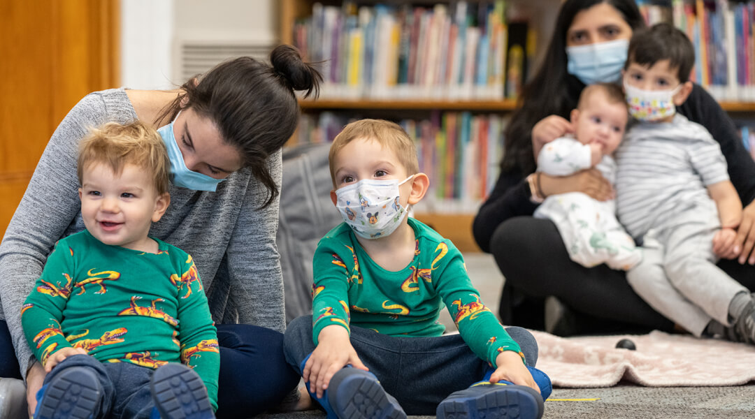Babies and toddlers snuggling with caregivers
