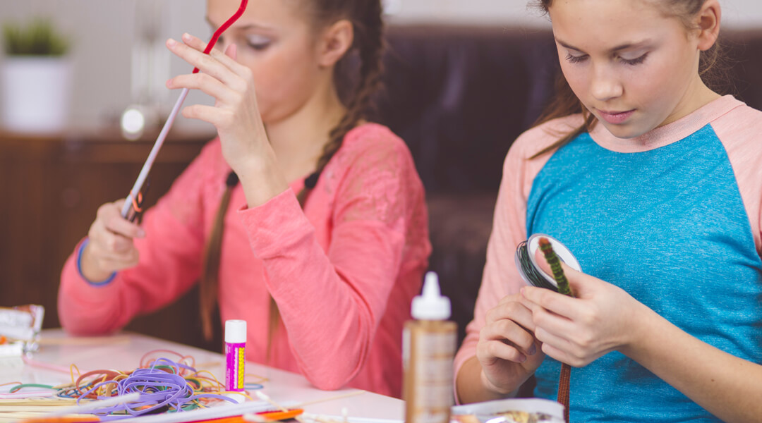 Two kids at table doing crafts