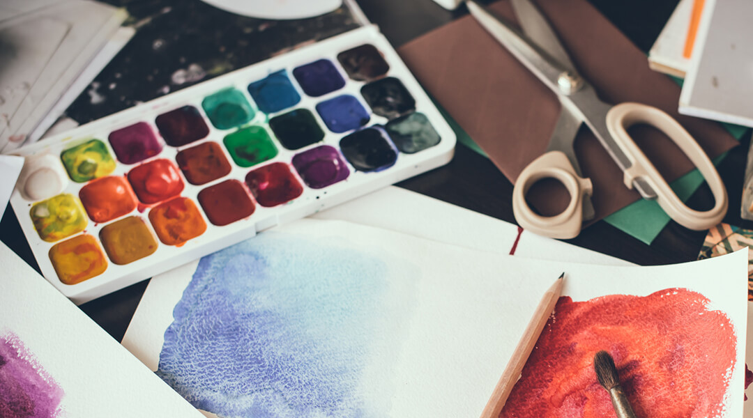 Watercolor paints, brushes and sketches, palette and painting tools