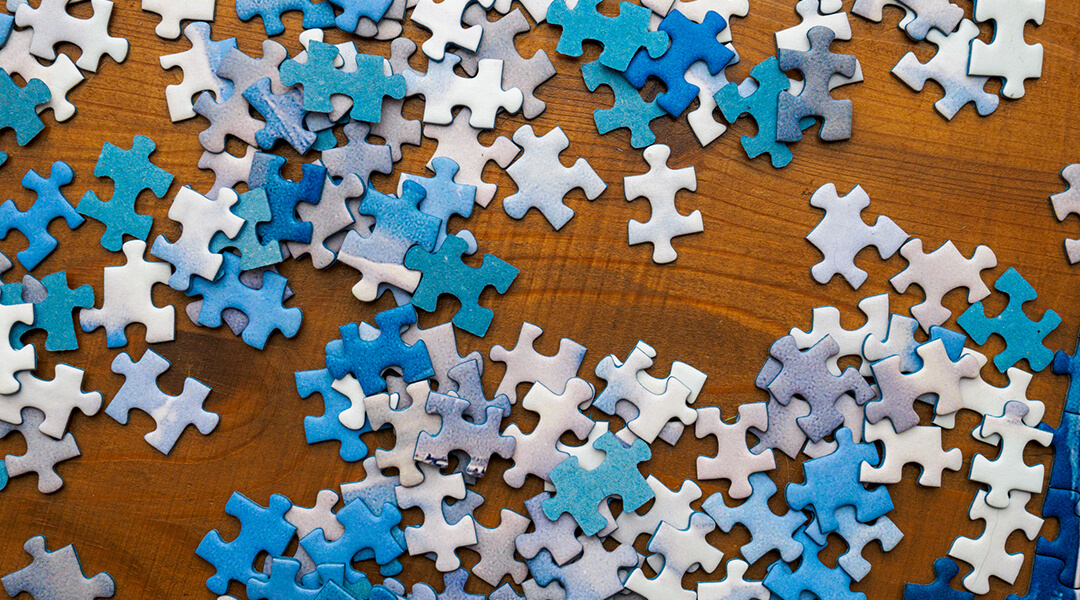 Photo of jigsaw pieces on a wood surface