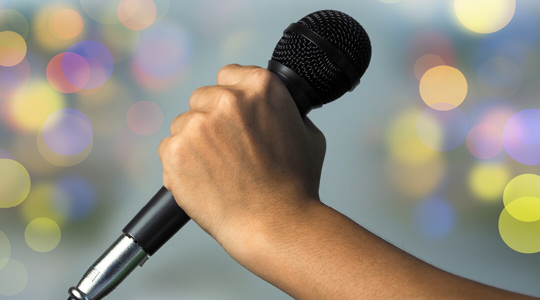 Close-up of a hand holding a microphone,