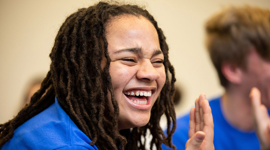 Close-up of a teenager's laughing face during Battle of the Books.