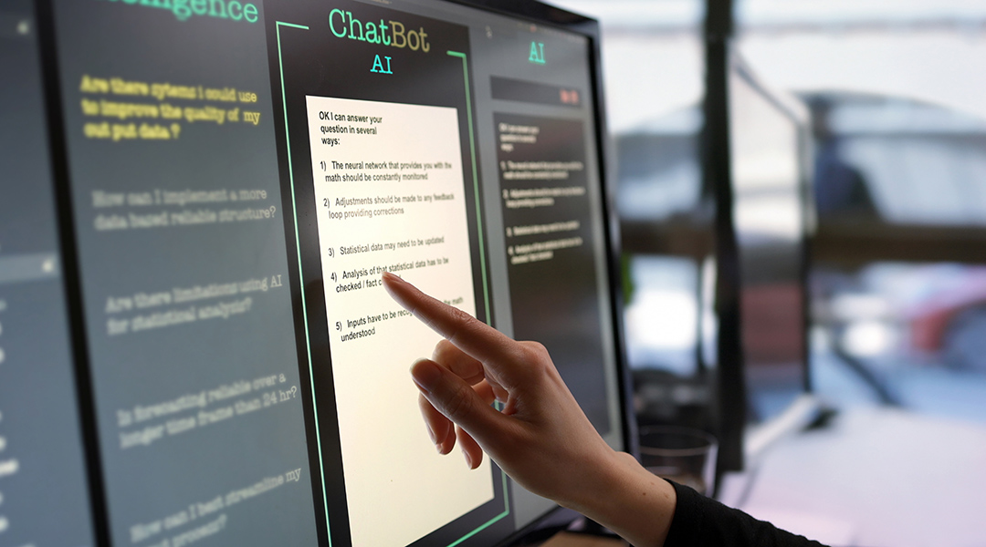 Close-up of a touchscreen monitor being used to work with an AI chatbot.