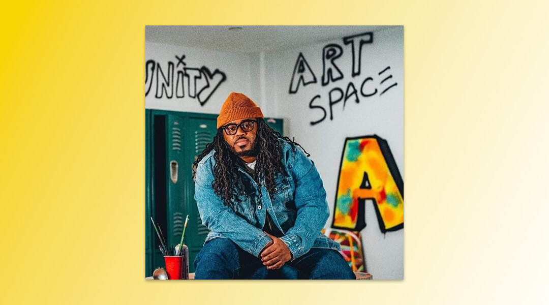 Photo of artist Cue Perry with lockers and graffiti in the background