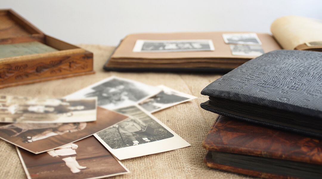 Old retro photo albums with vintage monochrome photographs in sepia color