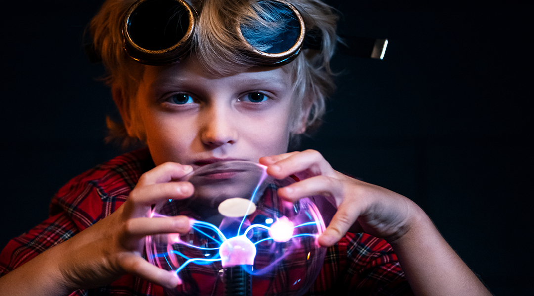 A child plays with a plasma ball.