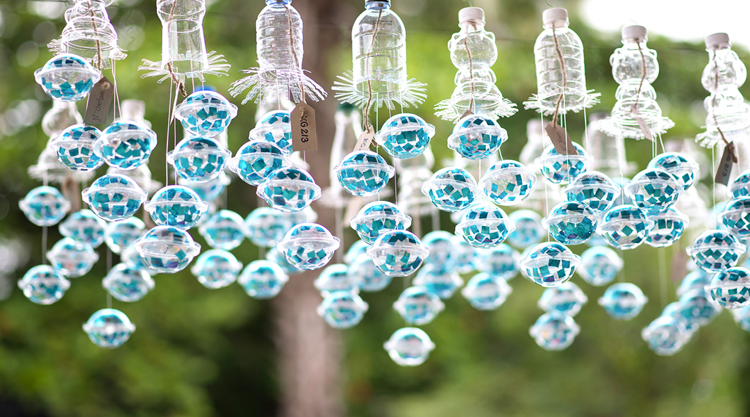 Glass windchimes hang from a porch.