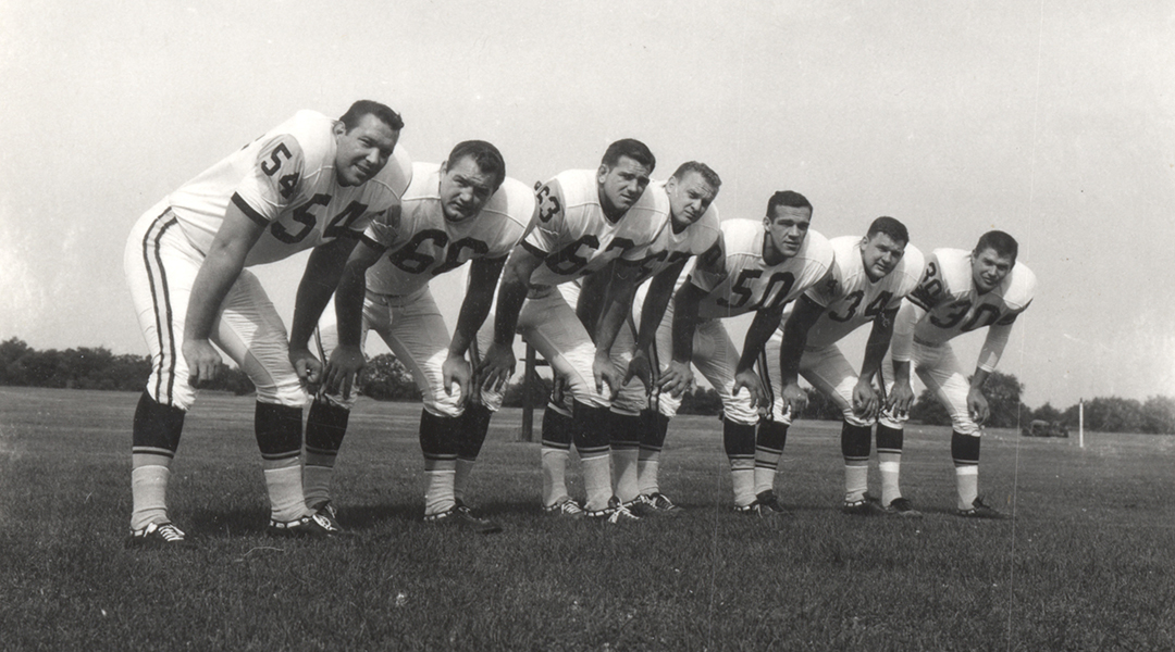Historic photo of football players in a lineup.