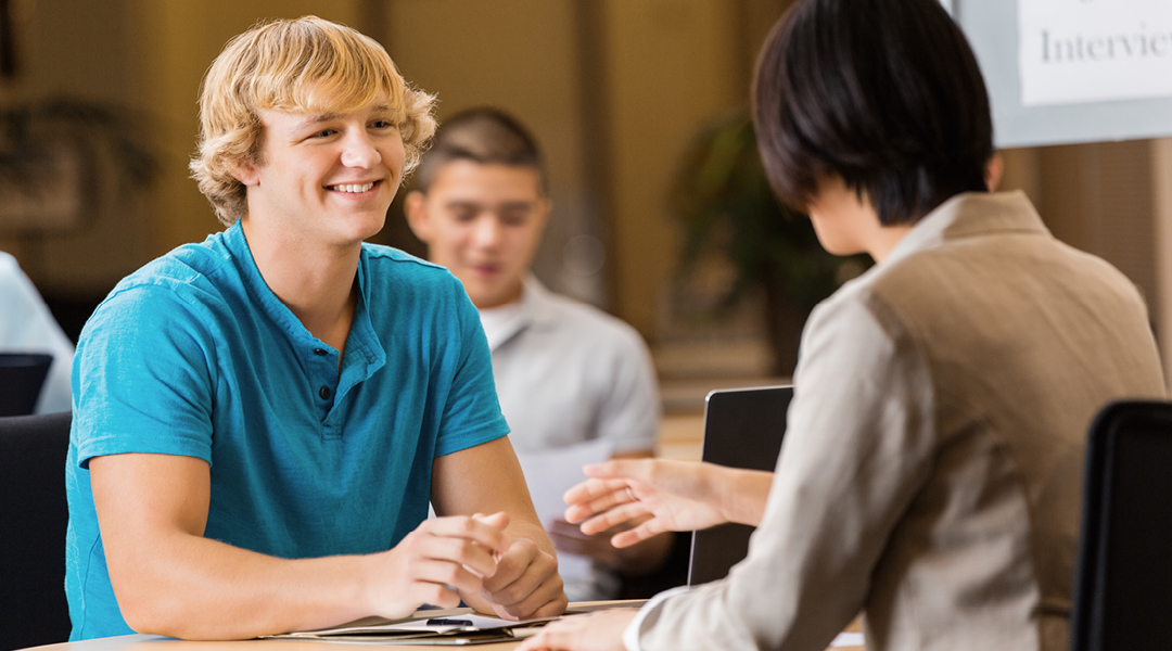 A teenager meets with a job counselor.