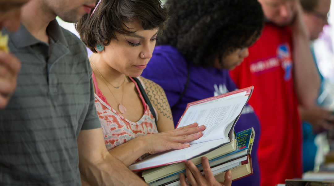 Woman looking at a book at a CLP Book Sale