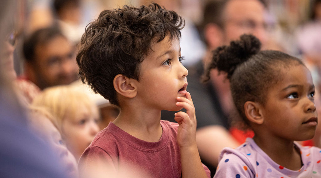 Little boy paying close attention to a library storytime