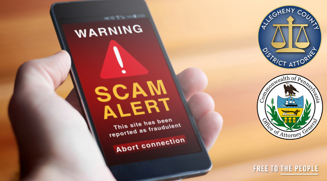 A hand holding a phone that shows an alert on the screen that reads WARNING SCAM ALERT