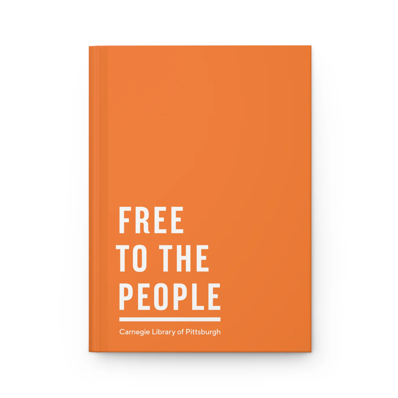 An orange hardcover notebook with printed text on the cover reading "Free to the People"