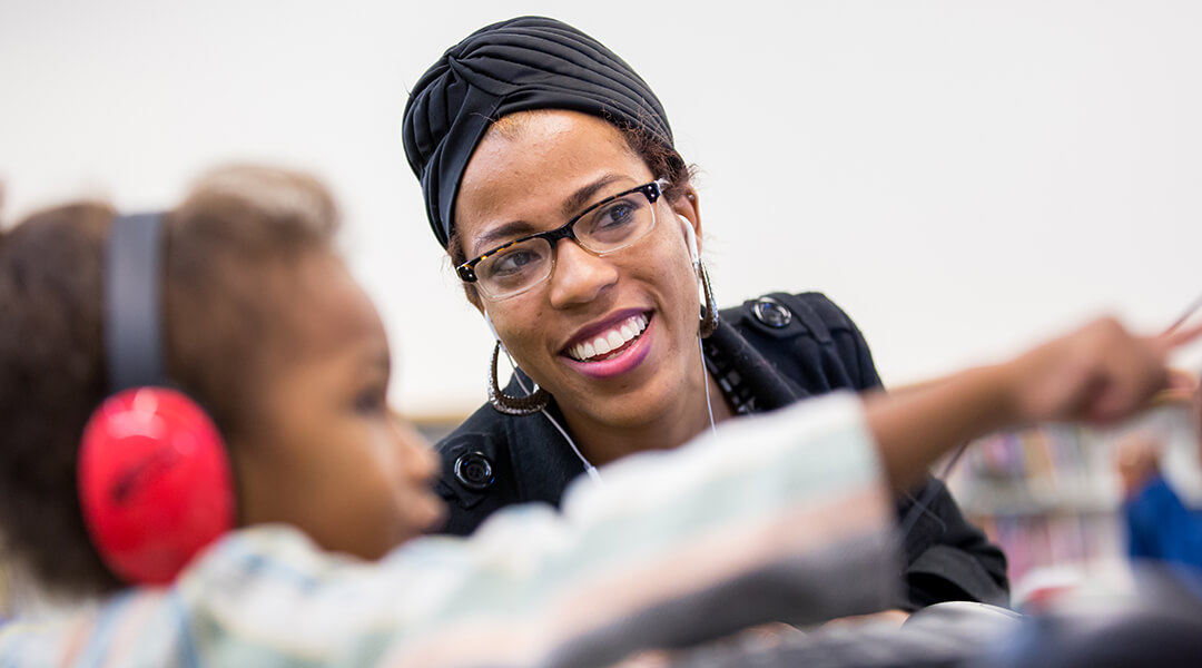 A CLP volunteer working with a child