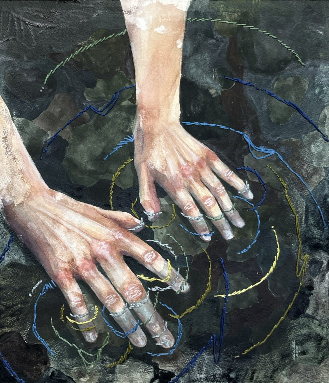 By Ava Wynne. Painting of two hands being submerged in water with a black background, surrounded by threads of yellow, blue, and green thread.