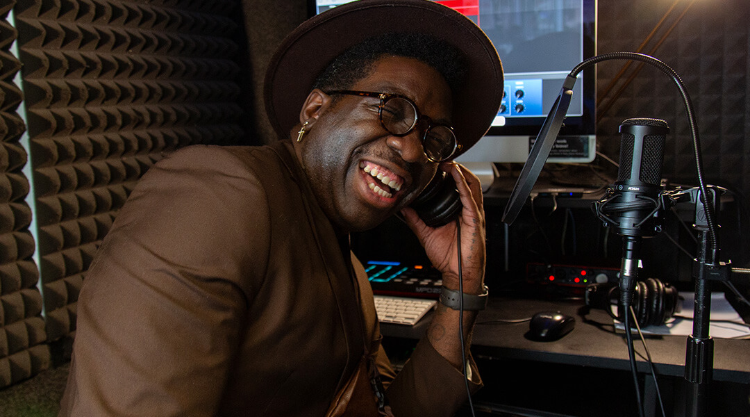 Harvey "Frzy" Daniels listens to an audio sample in a library recording booth.