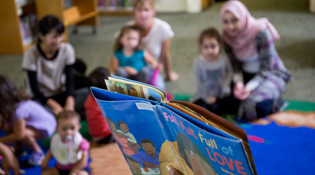 Children and parents being read to at a storytime